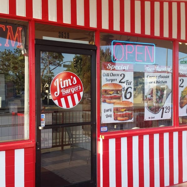 Jim's Burgers storefront with red and white stripes, an 'OPEN' neon sign, and chili cheese burger specials.