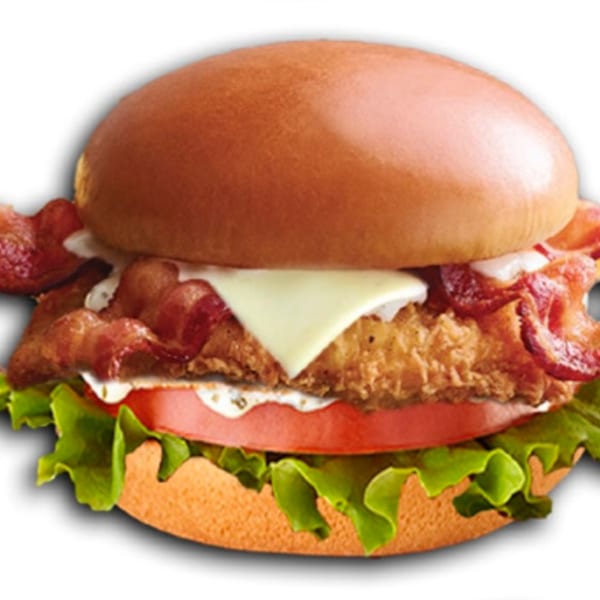 Jim's Burgers chicken sandwich with bacon, cheese, tomato, lettuce, and sauce on a bun.