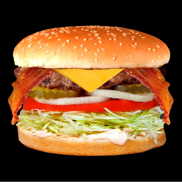 A Jim's Burgers bacon cheeseburger with lettuce, tomato, onion, and pickles on a sesame seed bun.