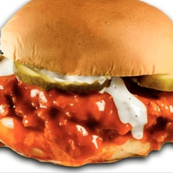 A Jim's Burgers spicy chicken sandwich with pickles and ranch dressing on a bun.