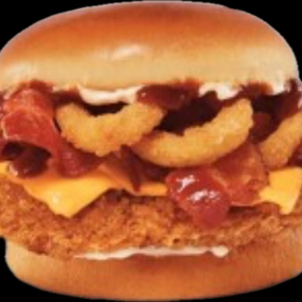 A Jim's Burgers chicken sandwich with bacon, onion rings, cheese, and BBQ sauce.